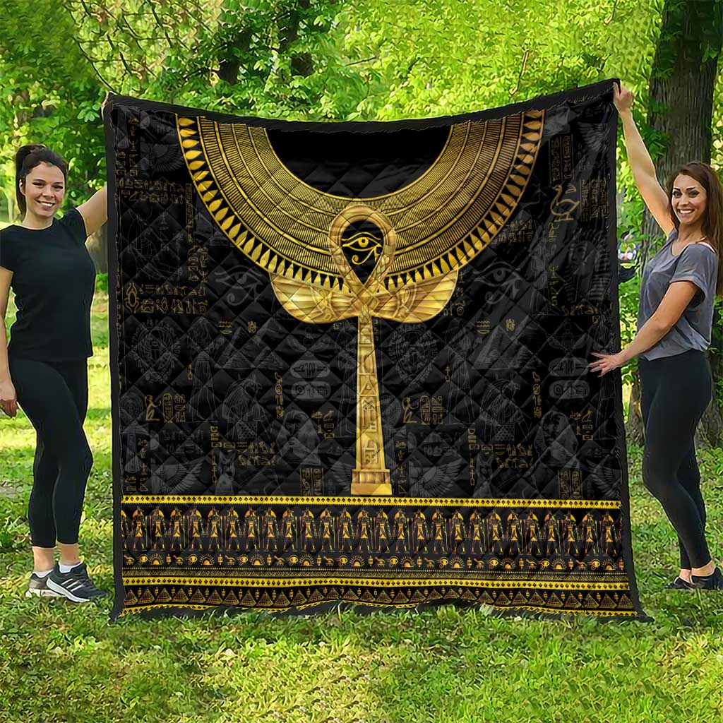 Black Egyptian hieroglyphs quilt with gold ankh centerpiece and gold trim, full spread