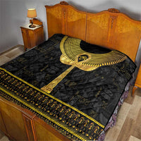 Black Egyptian hieroglyphs quilt with gold ankh motif and decorative border, on bed
