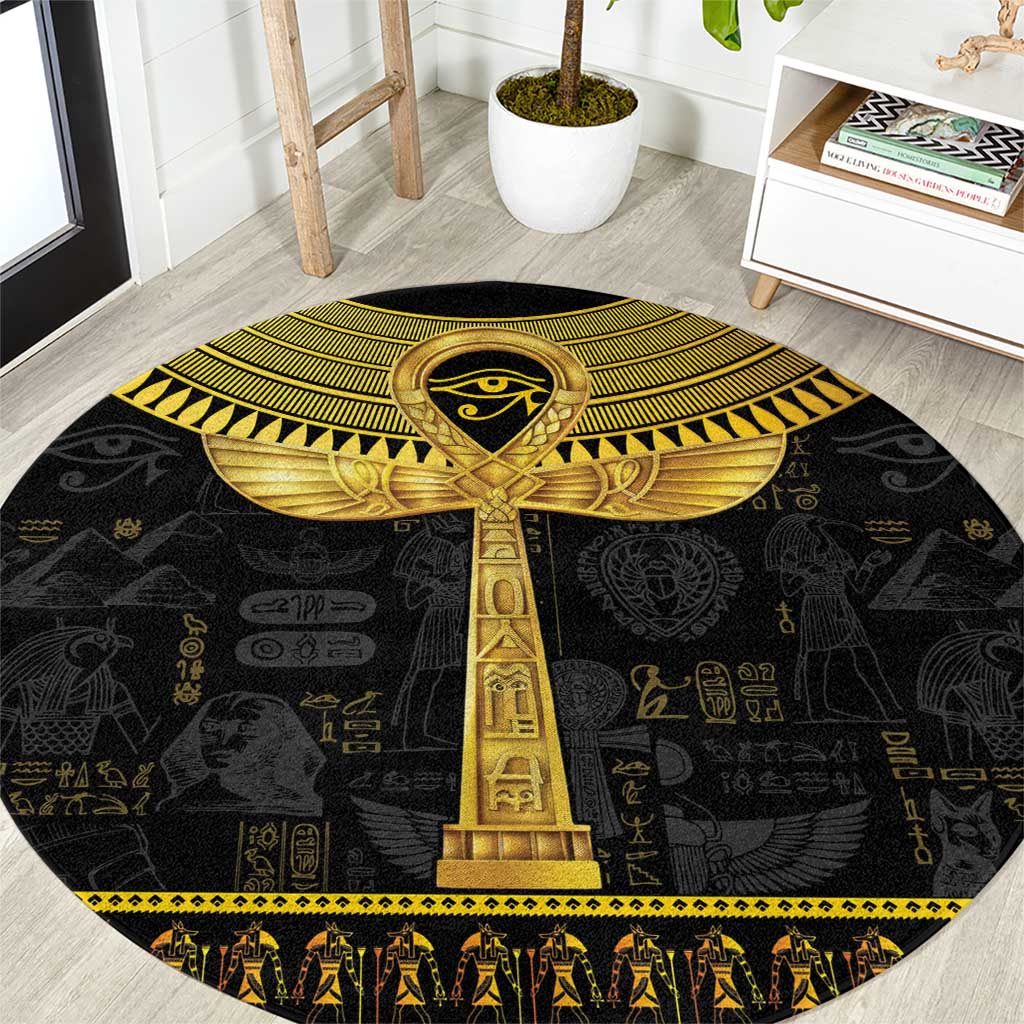 Black round carpet with gold Egyptian ankh and hieroglyph patterns, border trim.