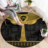 Black round carpet with gold Egyptian ankh column design and hieroglyphs, patterned edge.