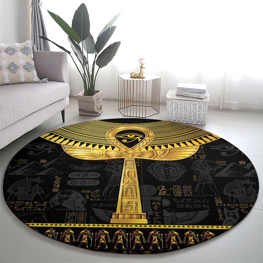 Black round area rug with central gold ankh and Egyptian symbols, decorative border.