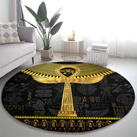 Black round area rug with central gold ankh and Egyptian symbols, decorative border.