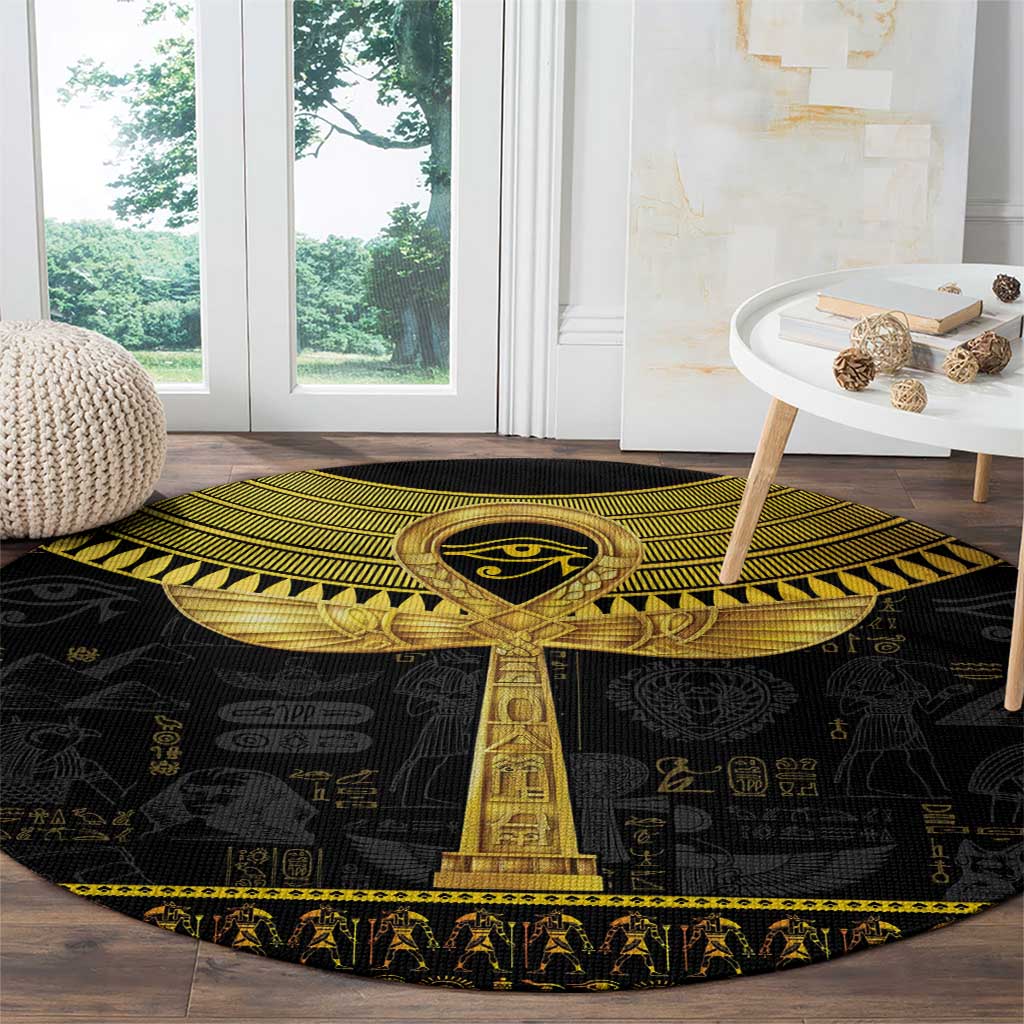 Black round carpet with gold Egyptian ankh column centerpiece and hieroglyph backdrop pattern.