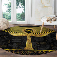 Black round carpet with gold Egyptian ankh column centerpiece and hieroglyph backdrop pattern.