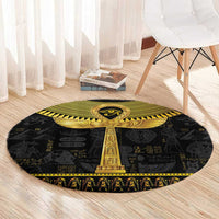 Black round rug with gold ankh design centered, hieroglyph motifs and patterned border.