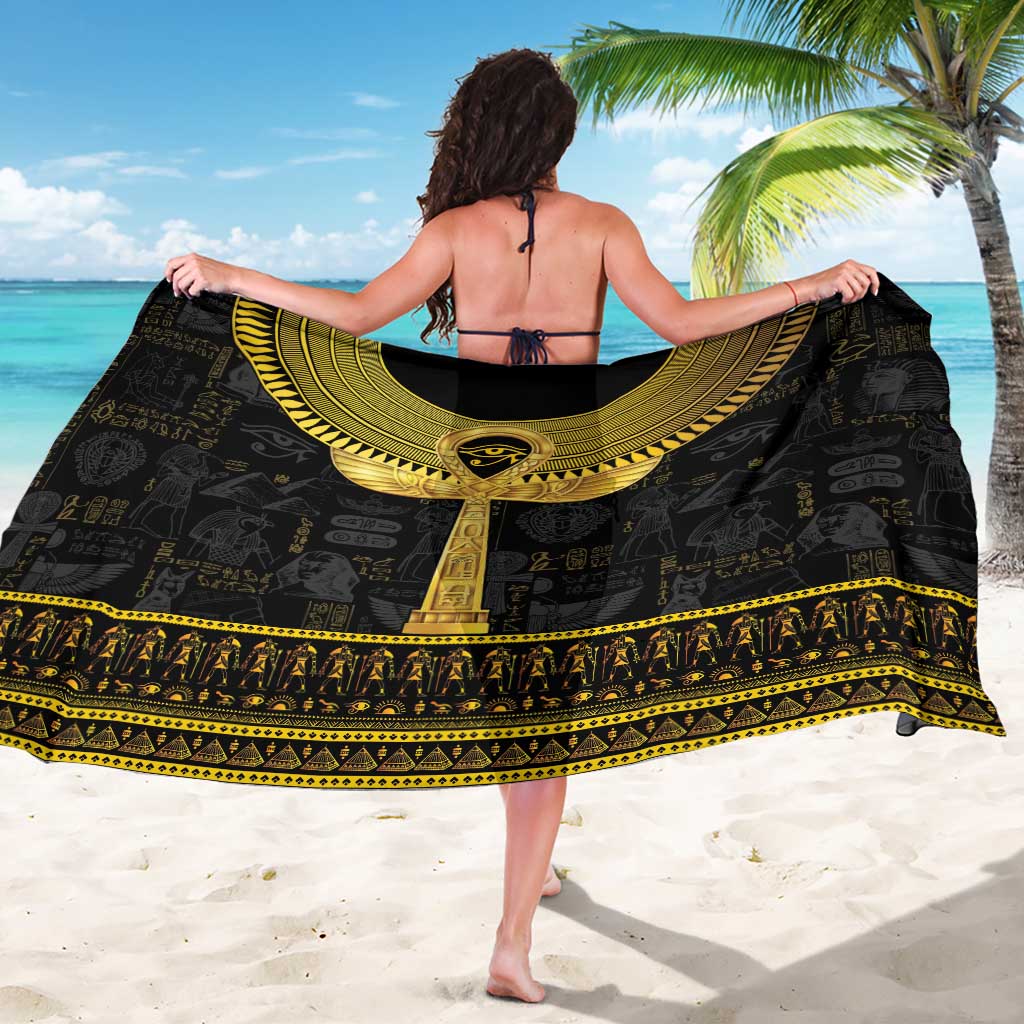 Black sarong with gold ankh medallion and arched hieroglyph band, held open