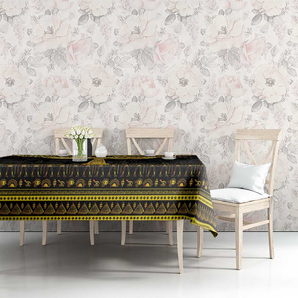 Black Egyptian hieroglyph tablecloth with gold border pattern on dining table