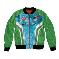Green bomber jacket with blue graphic panel, front zipper, and black ribbed cuffs and hem