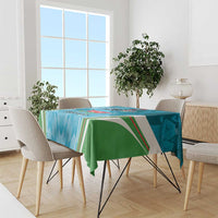 Blue tablecloth with green edge, draped on dining table with printed emblem stripes