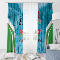 Blue and green printed window curtains with white diagonal stripes and red map details