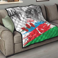 Flag-style quilt draped on sofa, gray graphic top with red flowers, crescent and star