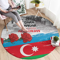 Round carpet showing Qara Yanvar 20.1.1990 AZERBAIJAN text, flag stripes and red flowers