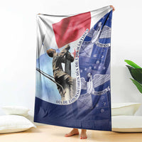 Panama flag themed blanket draped over sofa, black statue and blue geometric emblem