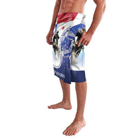 Blue flag-print swim shorts shown at an angle with red stripe and emblem graphics