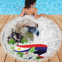 White round beach blanket with eagle face, tropical floral accents, and tassel fringe