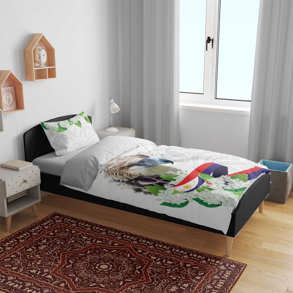 White bedding set on bed with bird, green floral details and flag ribbon print