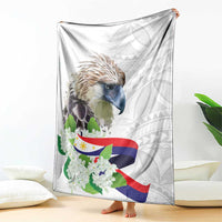 White eagle blanket draped with Philippines flag stripes and sampaguita flower print