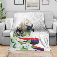 White eagle and sampaguita flowers blanket on gray sofa with subtle geometric background