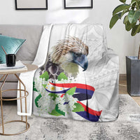 White eagle blanket on gray rug with Philippines flag stripes and sampaguita flowers