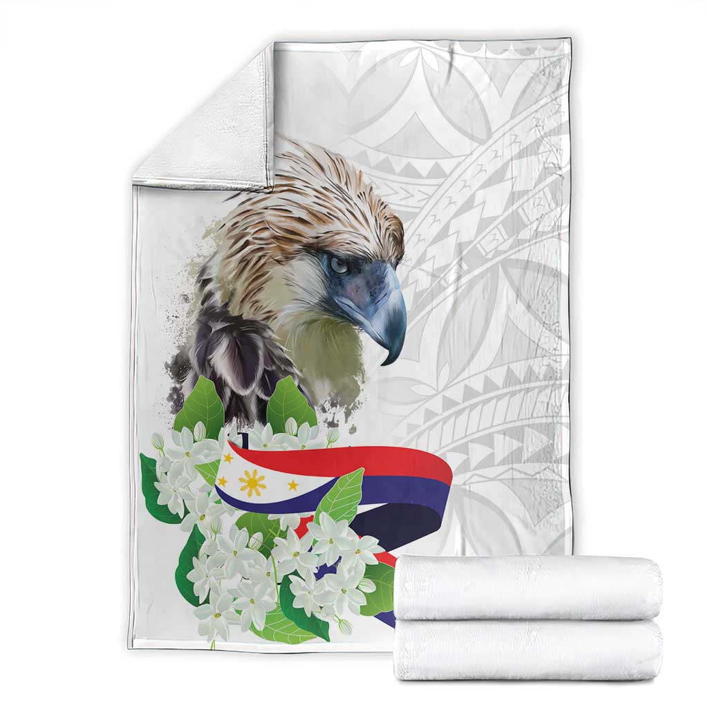 White eagle and sampaguita blanket with Philippines flag print, folded with rolled blankets