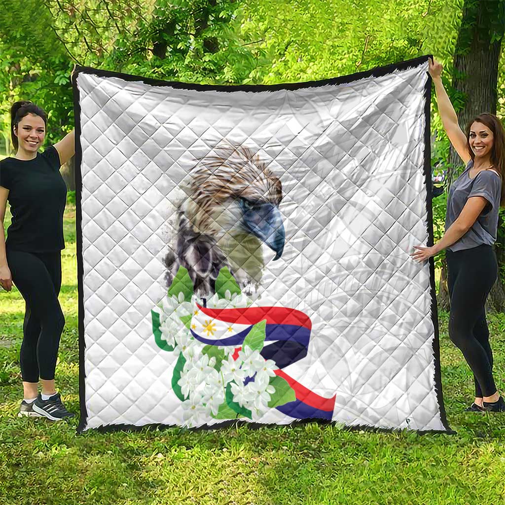 White diamond-quilted blanket with eagle artwork, Philippine flag design, and sampaguita flowers.