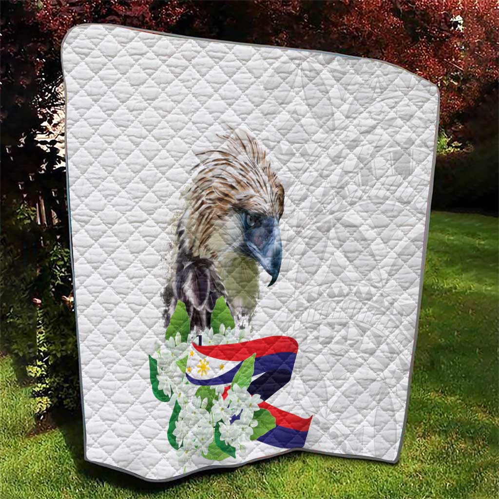 White quilt blanket with diamond quilting, showing an eagle head, flag colors, and flowers.