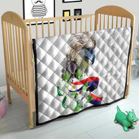 White quilt for a crib with diamond quilting, eagle artwork, Philippine flag, and sampaguita.