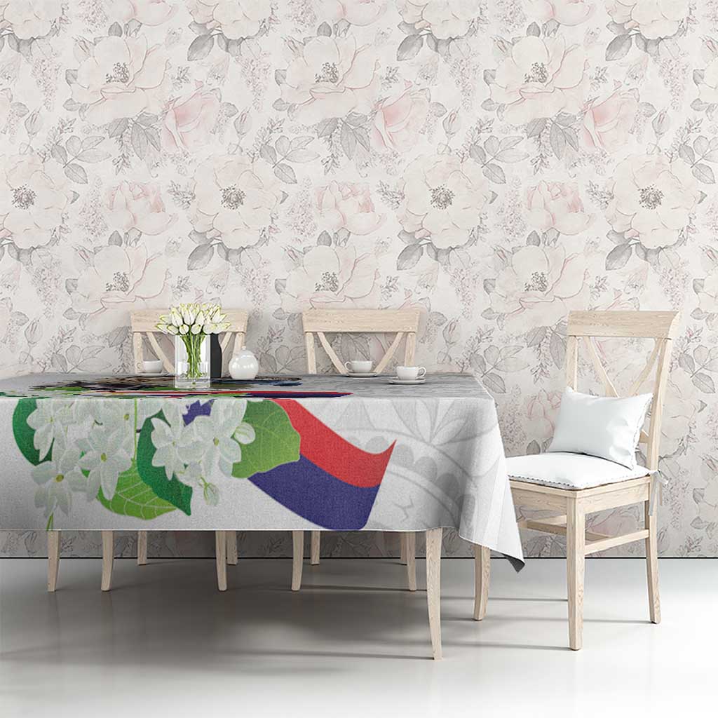 White tablecloth with polynesian eagle and sampaguita floral pattern on long dining table