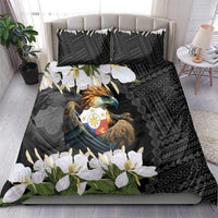 Black duvet and two pillowcases with eagle crest, geometric motifs, and white flowers