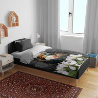 Black bed set with eagle crest artwork, geometric pattern, and white jasmine flowers