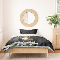 Black duvet with eagle crest and white blossoms over geometric patterned sides