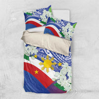 Philippines flag bedding set laid flat: duvet and pillows with blue tribal pattern and white jasmine