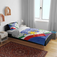 Philippines flag bedding set on bed: blue tribal print with white jasmine flowers and sun emblem