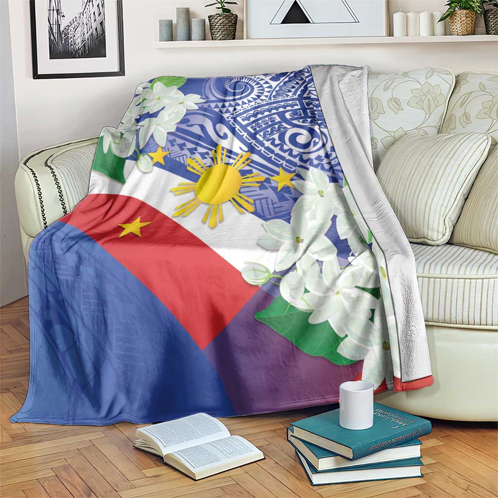 Philippines flag blanket with blue tribal print and white jasmine flowers on sofa with books