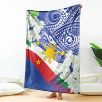 Philippines flag blanket with blue tribal design and white jasmine flowers, standing on floor