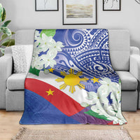 Philippines flag blanket with blue tribal print, white jasmine flowers, draped on couch