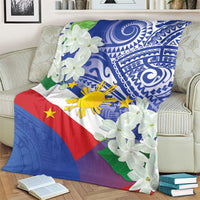 Philippines flag blanket with blue tribal print and white jasmine flowers on sofa
