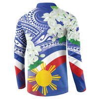 Blue long-sleeve button polo sweatshirt, angled view with white flowers and sun-star graphic