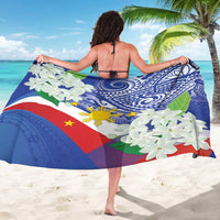 Blue draped sarong with Polynesian tribal motifs, white jasmine flowers, and yellow sun