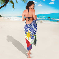 Blue sarong wrap with Polynesian tribal pattern, red and green flag stripes, and yellow sun