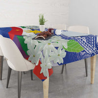 Philippines flag tablecloth with blue tribal motif and white jasmine blossoms on table.