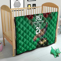 Green quilt on a child bed frame, red roses and bird graphic with 993 and 21.
