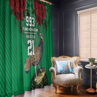 Green curtain panel with red rose design and bird print, hung beside a window and chair