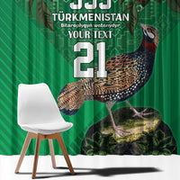 Green window curtain with large bird illustration and red roses, styling a chair in front