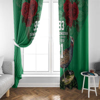 Green curtain panels with red rose graphics and bird print, draped on both sides of a window