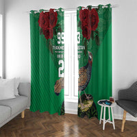 Green curtain pair with red rose graphics and bird design, hanging on a window in a living room