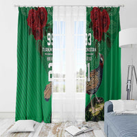 Green curtain panels with red roses and bird print, suspended with hooks over a window