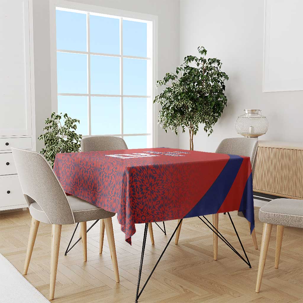 Red custom football tablecloth with blue diagonal side stripe and abstract pattern over dining table.