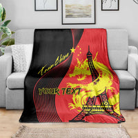 Red and black blanket with Eiffel Tower and dragon flame design on a sofa