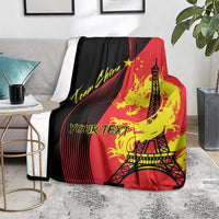 Red, black and yellow blanket with Eiffel Tower and dragon flames, draped on a couch